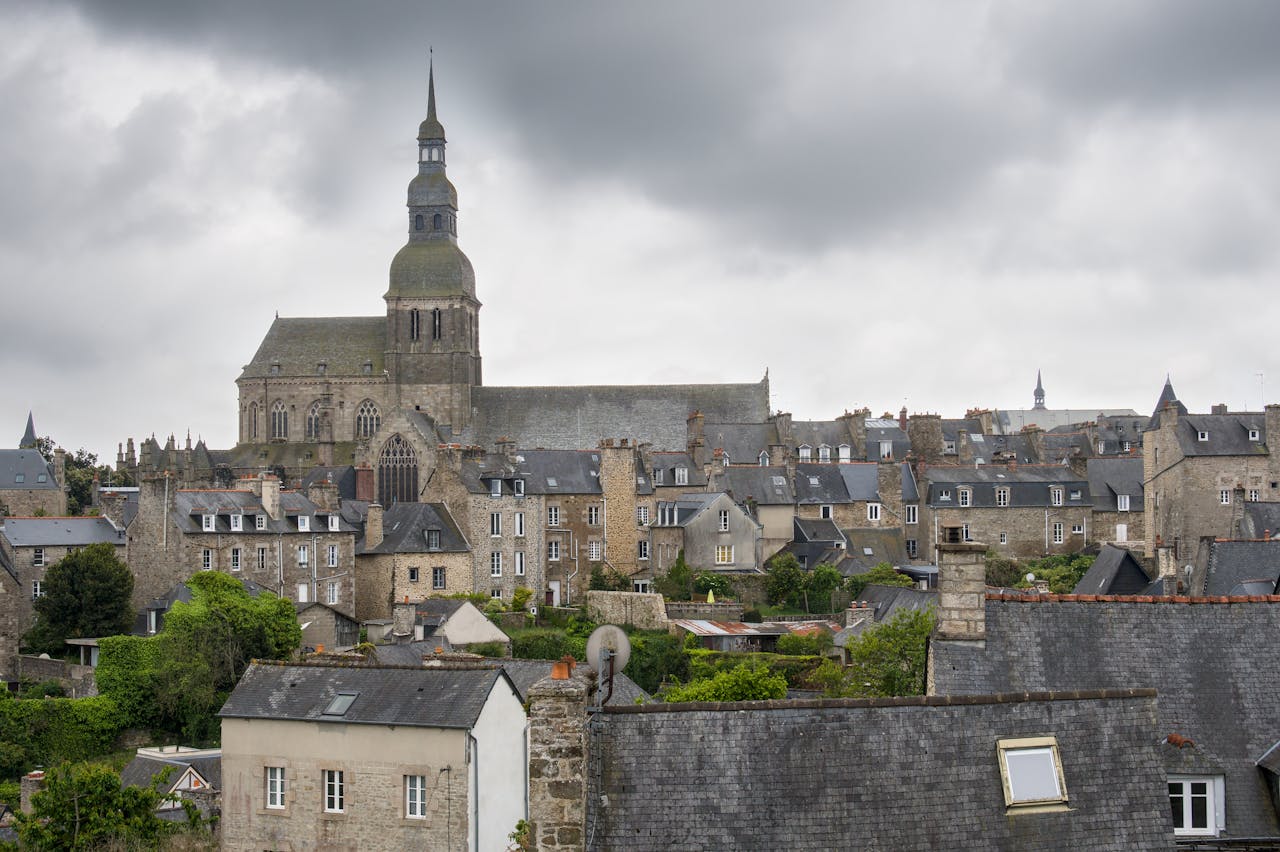 team-02 Aerial view of Saint-Brieuc's historic rooftops with the imposing cathedral in cloudy weather.
