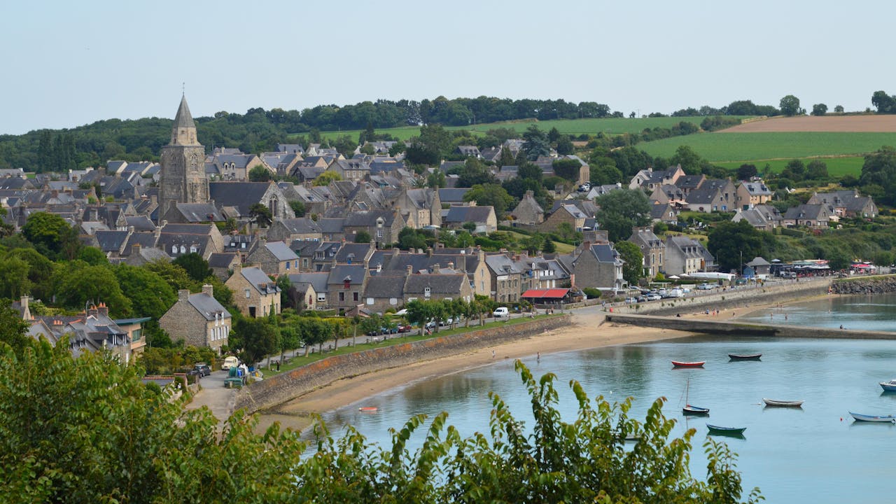 A picturesque view of the charming village of Saint-Suliac in Bretagne, France, overlooking the coast.